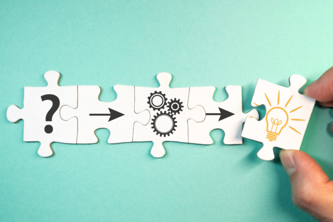 finding solution for a problem concept with jigsaw puzzle pieces