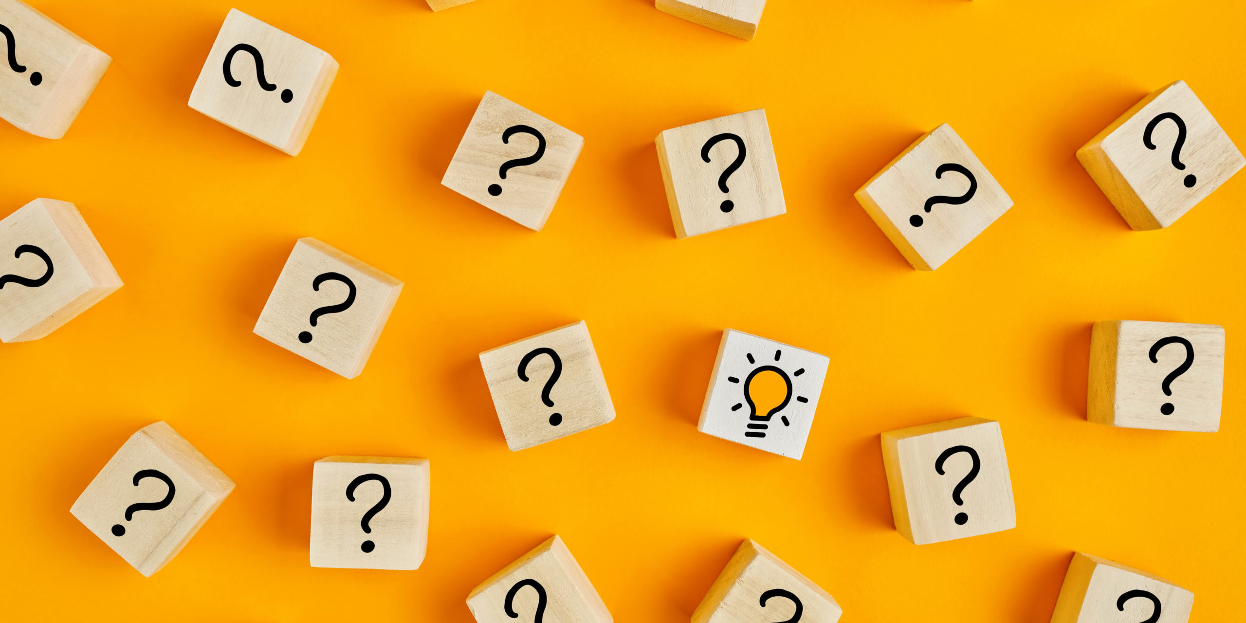 Concept of to find a creative idea or problem solving. Question mark and light bulb icons on wooden cubes