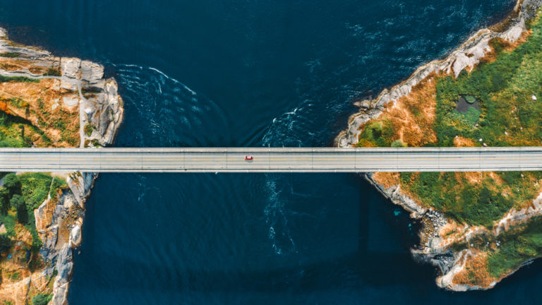 Aerial view Saltstraumen bridge in Norway road above sea connecting islands top down scenery transportation infrastructure famous landmarks scandinavian landscape