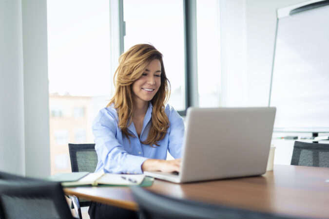 Shot of a businesswoman sitting at the office and using laptop for work